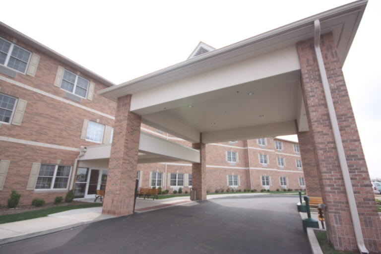 A residential building with a covered driveway entrance.