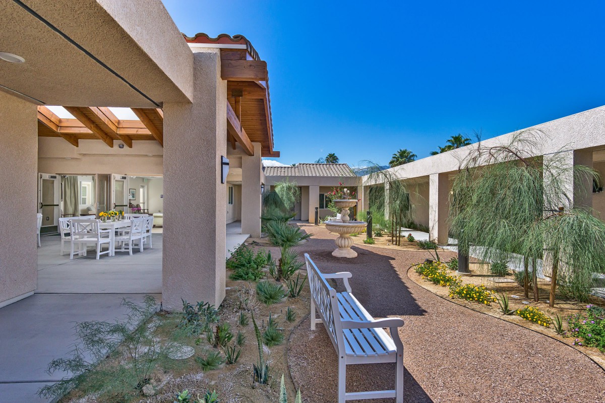 A modern outdoor space with pathways, benches, and contemporary architecture.