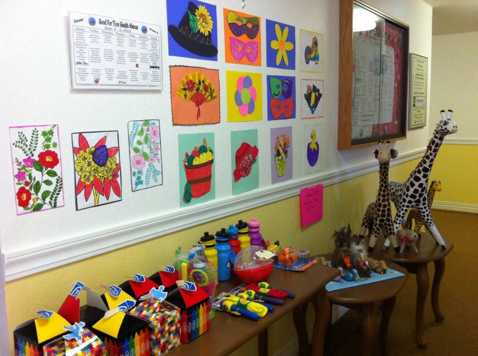 A colorful classroom wall showcasing children's artwork and crafts.