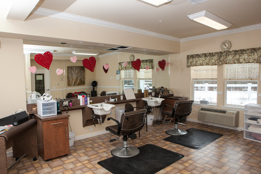 A cozy hair salon featuring styling stations with mirrors and comfortable chairs, decorated for a warm ambiance.