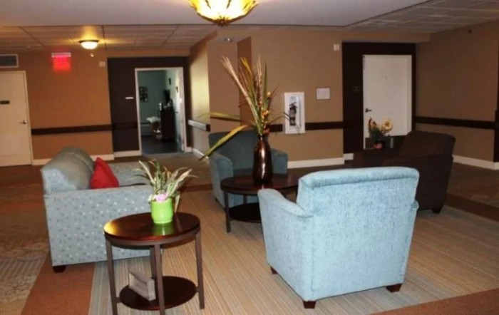 A cozy lounge area with comfortable seating and decorative plants.