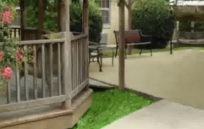 A peaceful garden with a wooden gazebo and benches.