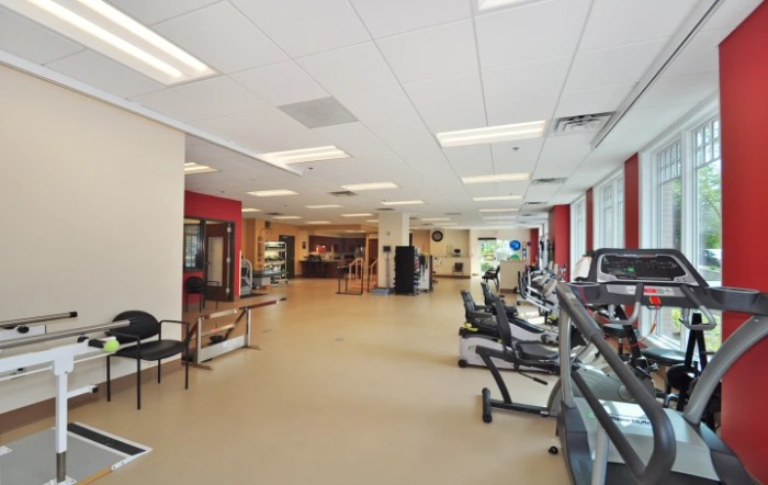 An indoor gym equipped with treadmills and various exercise machines.