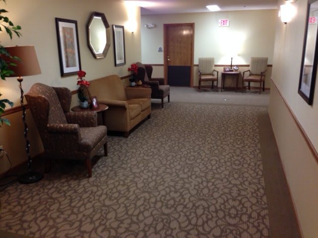 A hallway with seating arrangements and decorative elements.