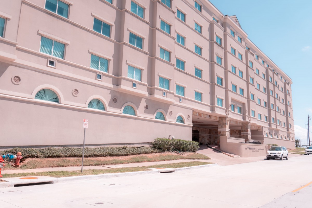 A multi-story building with numerous windows and a grand entrance.
