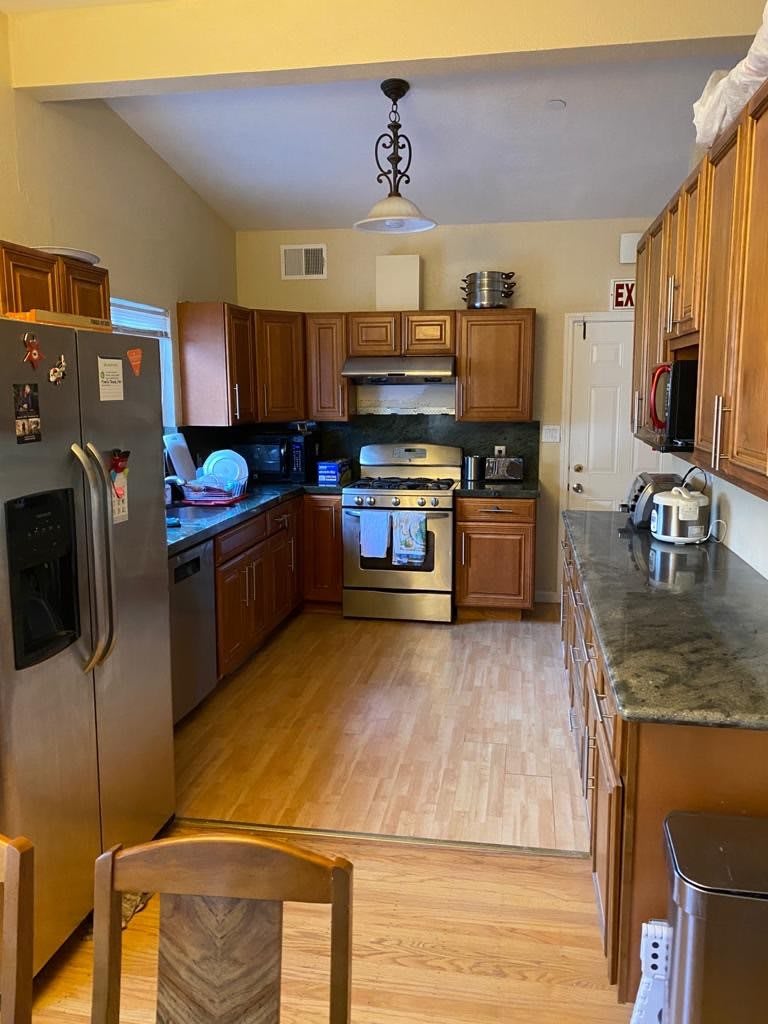 A cozy kitchen with wooden cabinets and modern appliances.