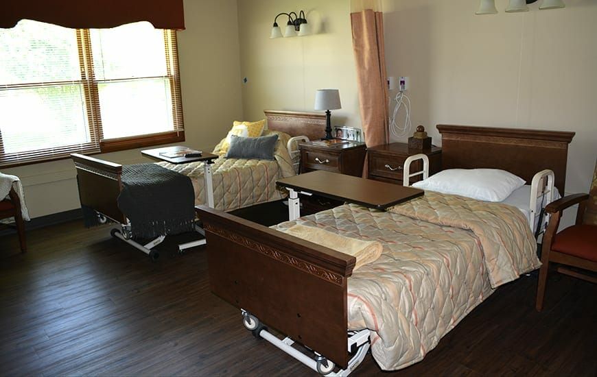 A hospital room with two beds and medical equipment, designed for patient care.