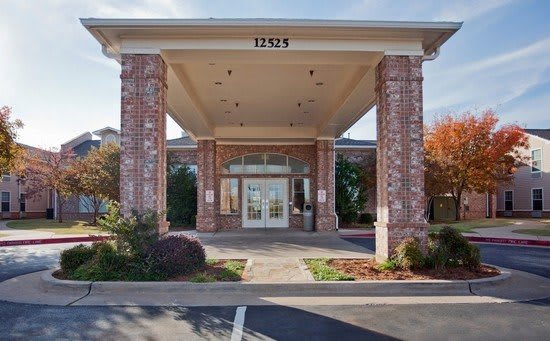 A building entrance with brick columns and an address number displayed above.