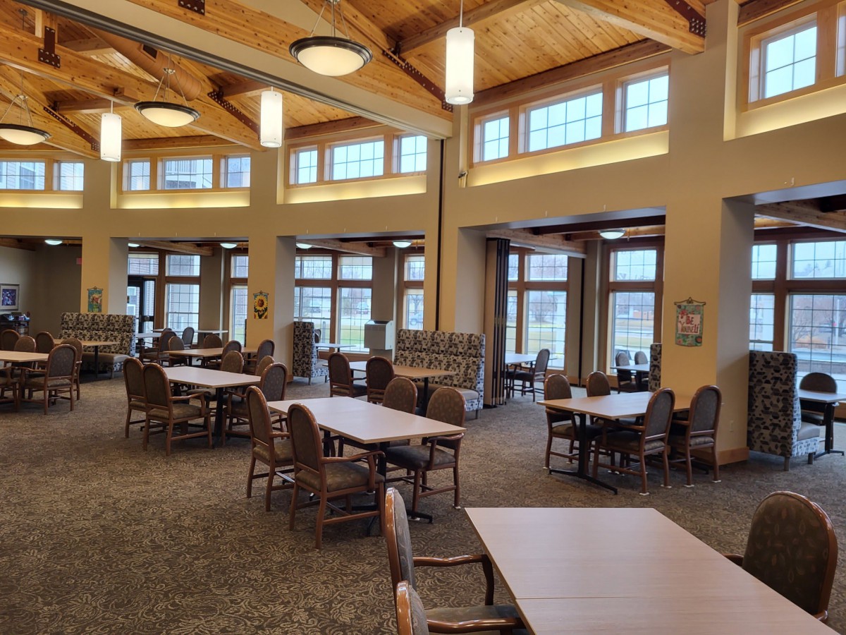 A spacious library interior with wooden ceilings and ample natural light.