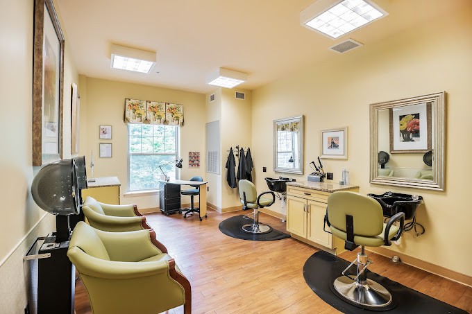 A well-lit hair salon interior with multiple chairs, mirrors, and equipment.