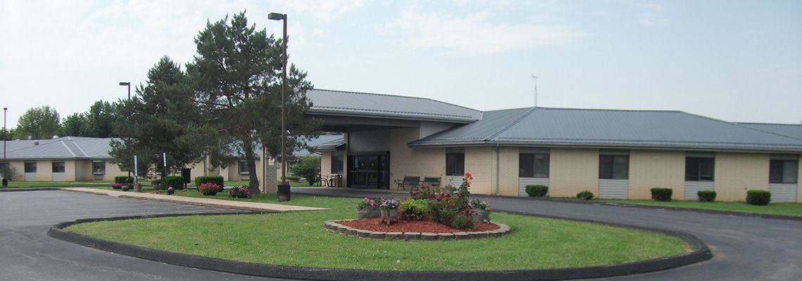 A modern building with a landscaped front garden.