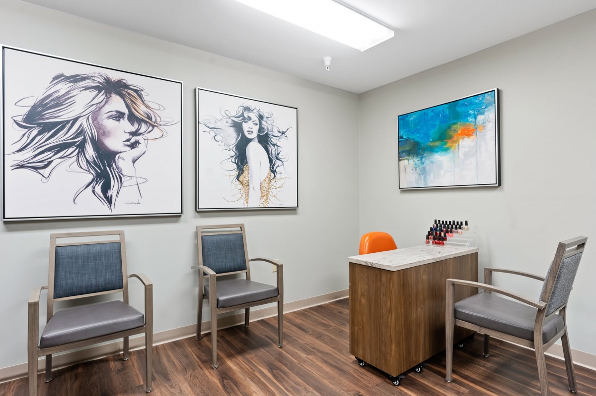 A modern waiting room with artwork and comfortable seating.