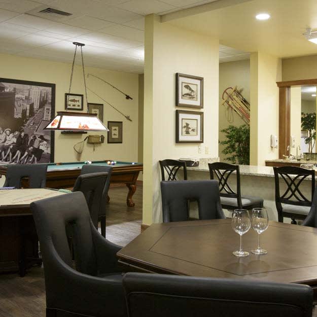 A cozy dining and recreation area featuring a pool table and elegant furnishings.