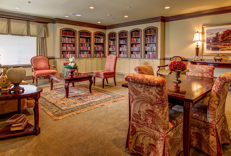 A cozy library with elegant seating and well-stocked bookshelves.
