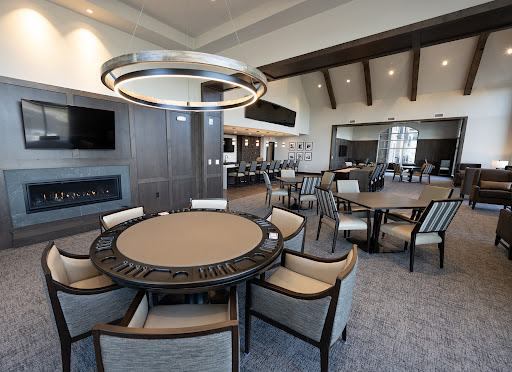 A modern dining room featuring stylish furniture and contemporary lighting.
