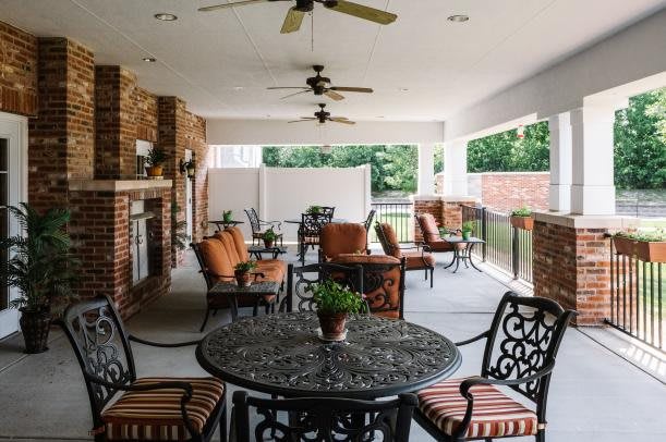 Spacious patio with comfortable seating and a fireplace.