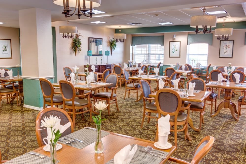 An elegantly decorated dining room with neatly arranged tables and chairs.