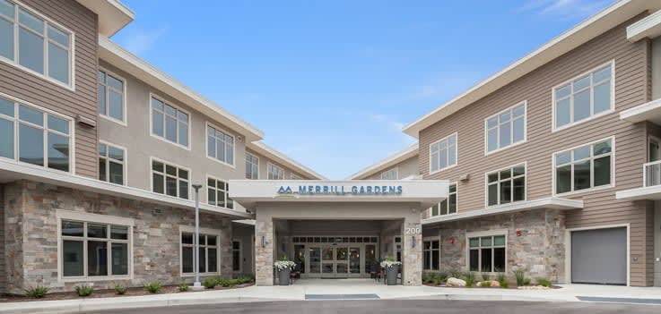 The front entrance of a Merrill Gardens retirement community building.