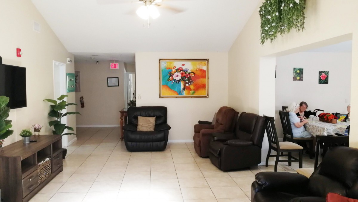 A cozy living room with leather sofas and a colorful abstract painting on the wall.
