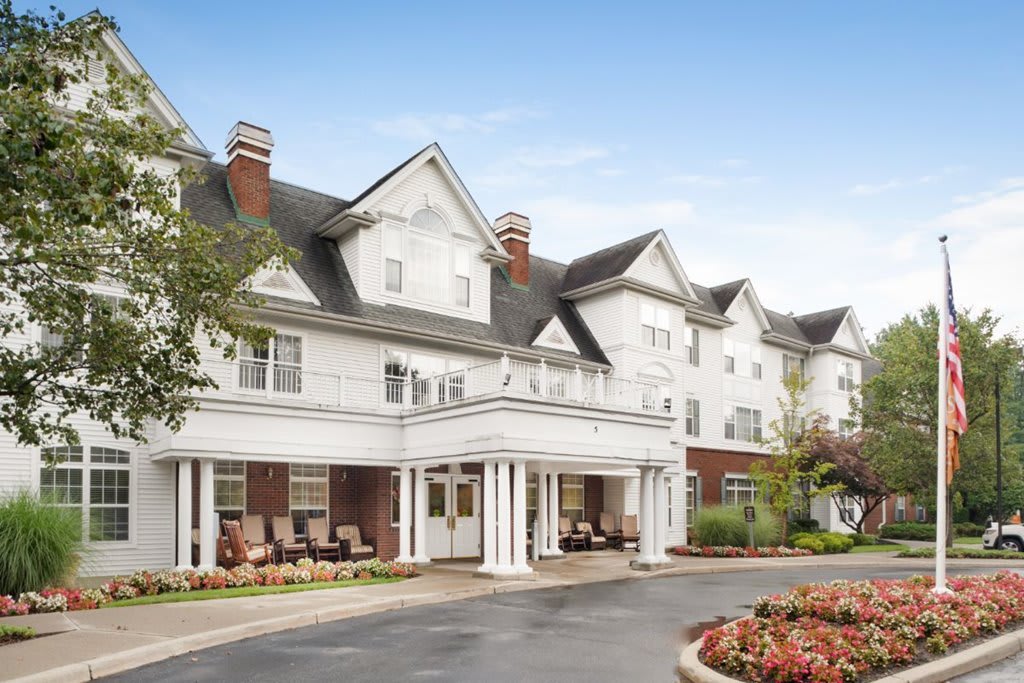 A large residential building with classic architecture and landscaped surroundings.