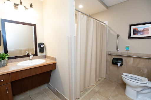 A clean and modern bathroom featuring a shower area, toilet, and vanity with sink.