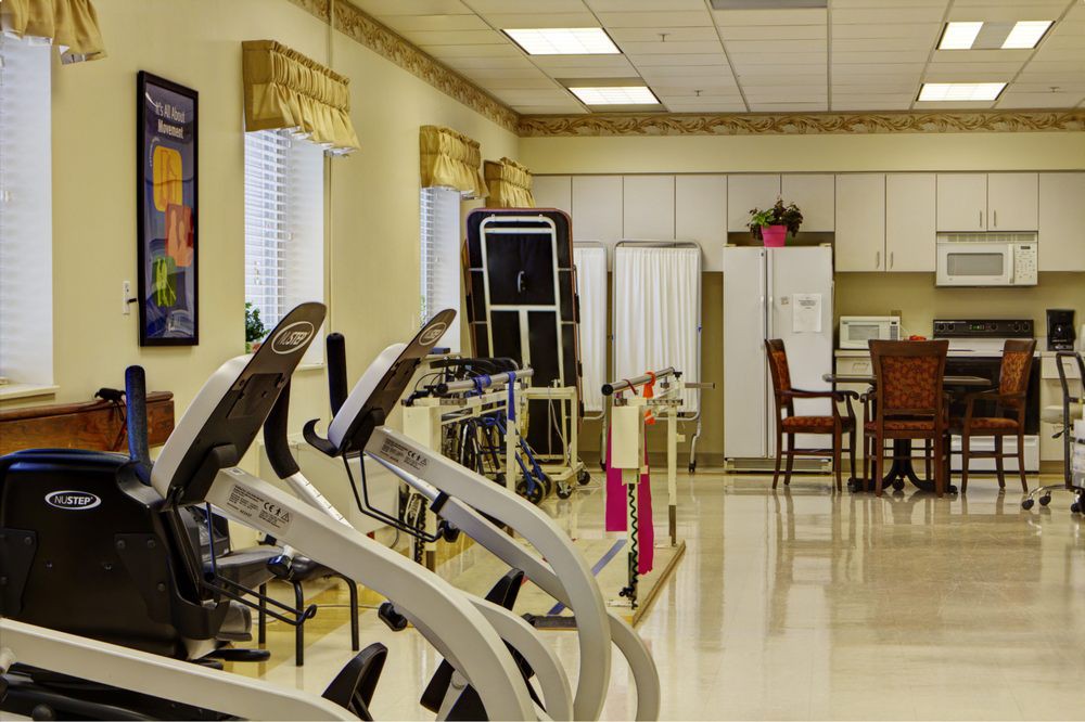 An indoor fitness center with various exercise equipment and treadmills.