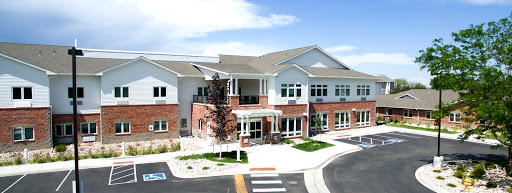 A modern community center with a welcoming entrance on a clear, sunny day.