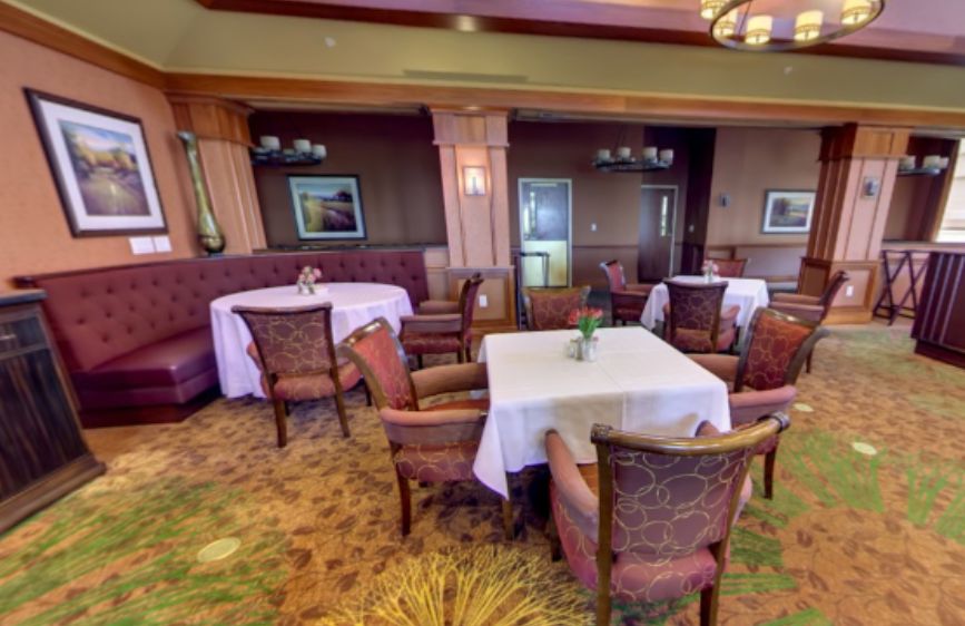 An elegantly decorated restaurant dining area with neatly arranged tables and chairs.