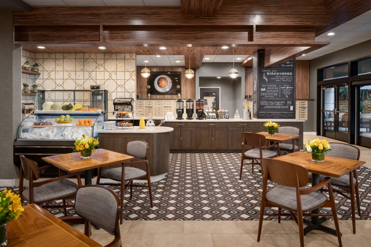 A modern cafe interior with wooden accents and stylish decor.