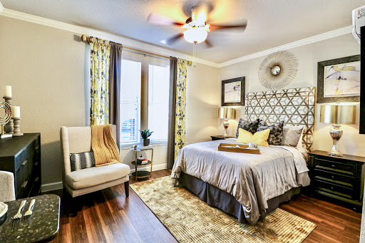 A stylish and cozy bedroom featuring modern decor elements and warm tones.