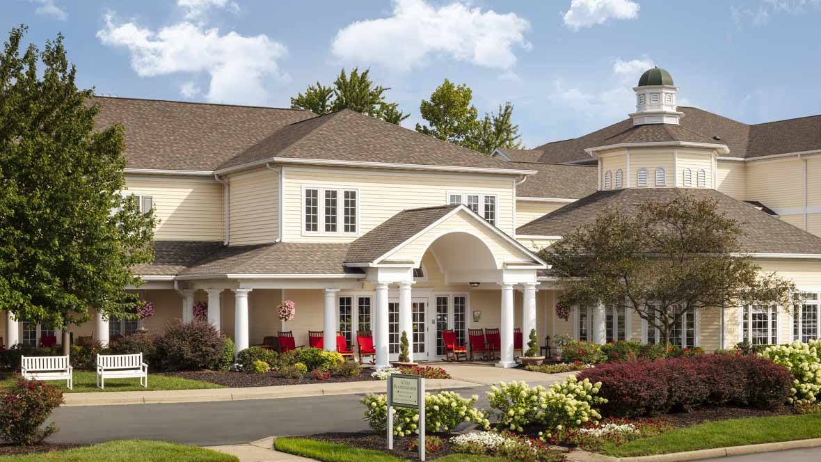 A large residential building with a landscaped garden and an inviting entrance.