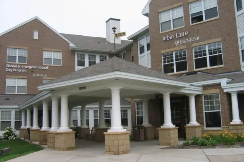 A residential building with a covered entrance supported by columns.