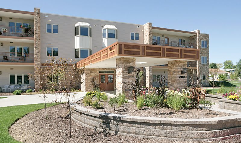 A modern residential building with landscaped surroundings.