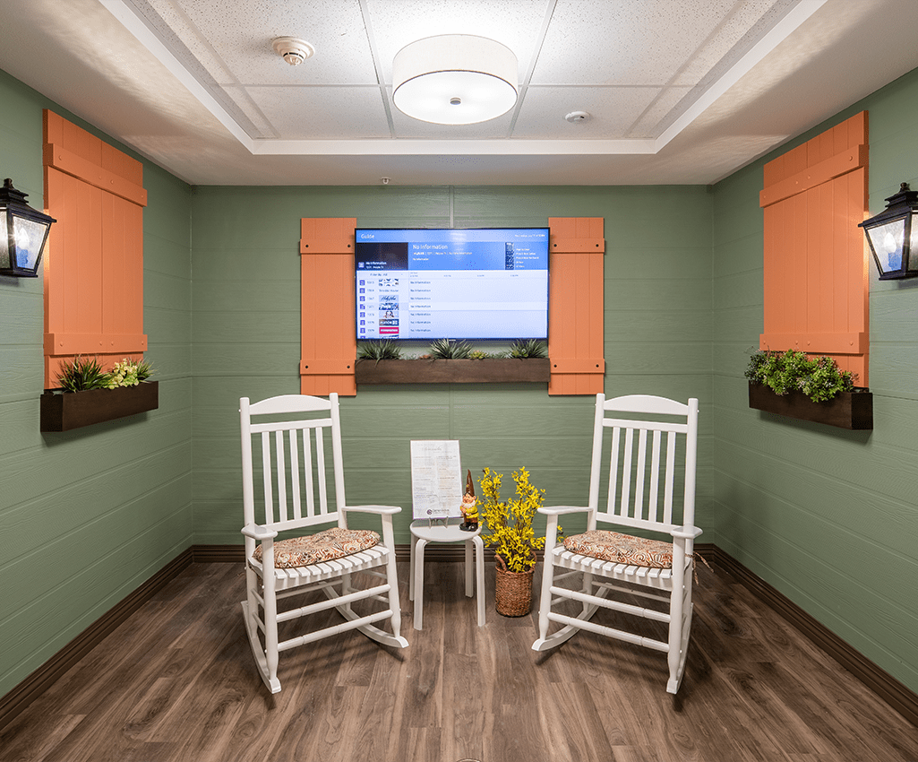 Cozy room with rocking chairs and a television.