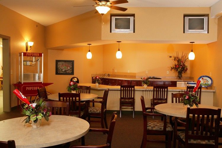 A cozy restaurant interior with a bar counter and multiple dining tables.