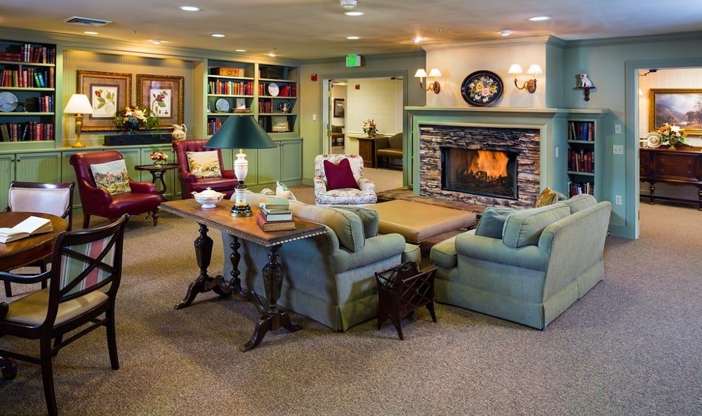 A cozy living room with comfortable seating and a warm fireplace.