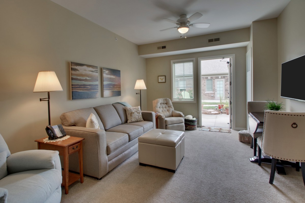 A cozy living room with modern furniture and ample natural light.