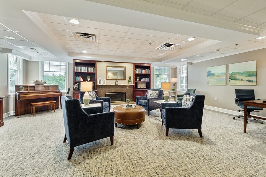 A cozy living room with plush seating, a central table, and built-in bookshelves.