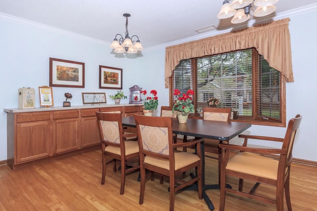 A cozy dining room with wooden furniture and decorative elements.