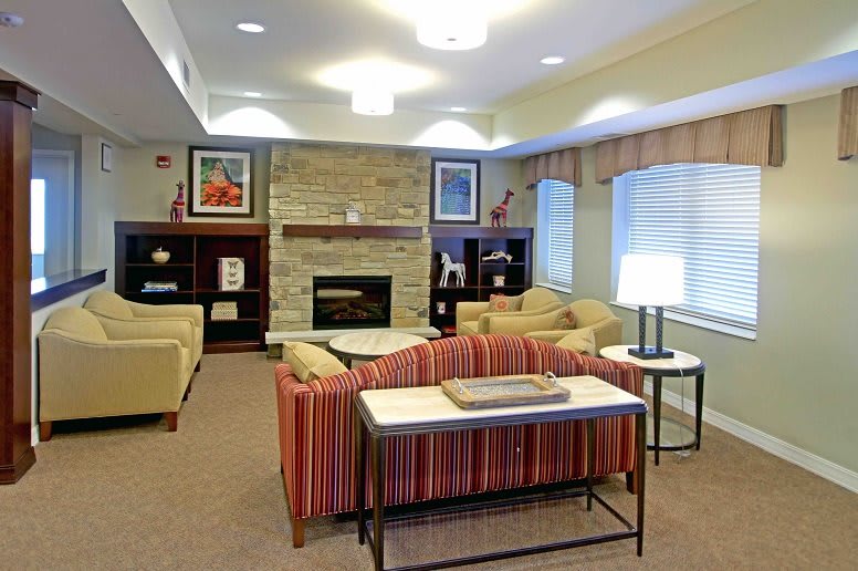 A cozy living room with comfortable seating and a warm fireplace.