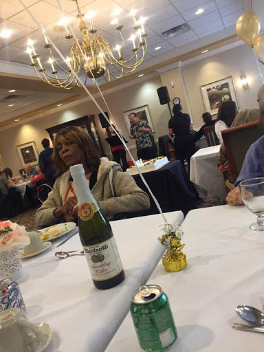 A cozy dining experience at a celebration with champagne and decorations.