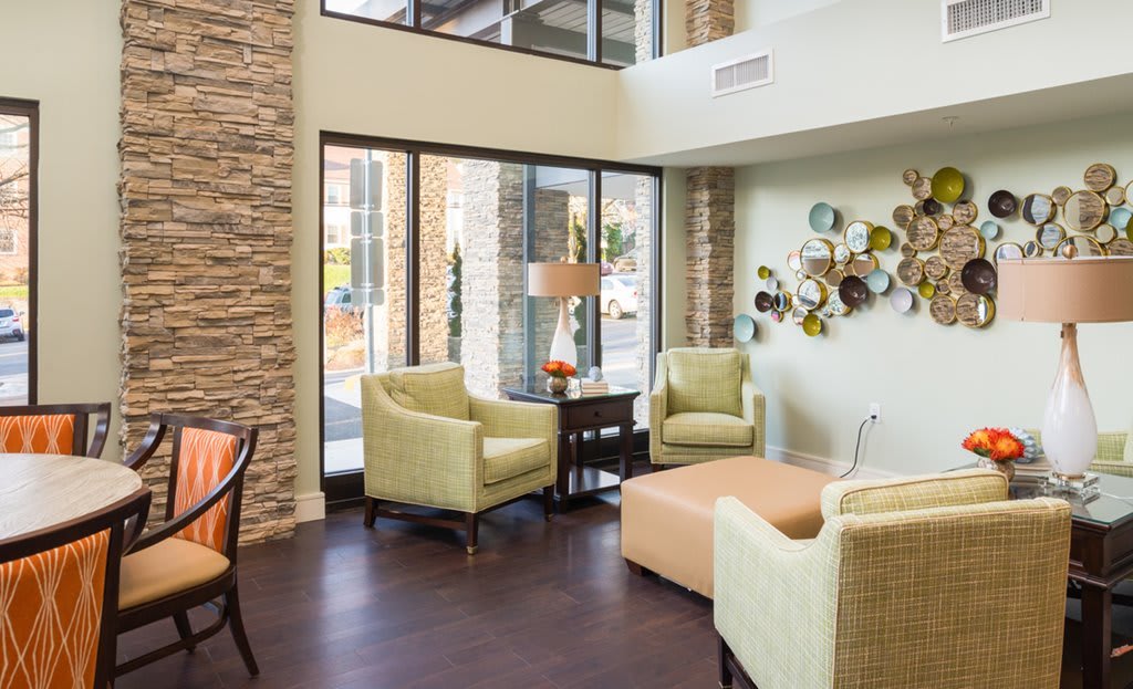 A modern living room with stylish furniture and ample natural lighting.