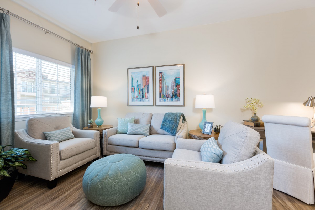 A cozy, modern living room with neutral tones and aquamarine accents.