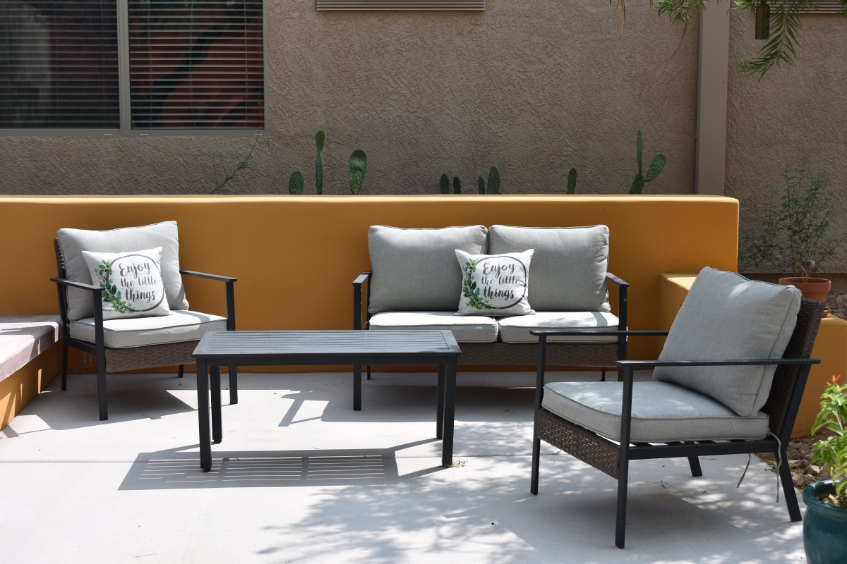 A cozy outdoor patio setup with cushioned chairs and a small table.