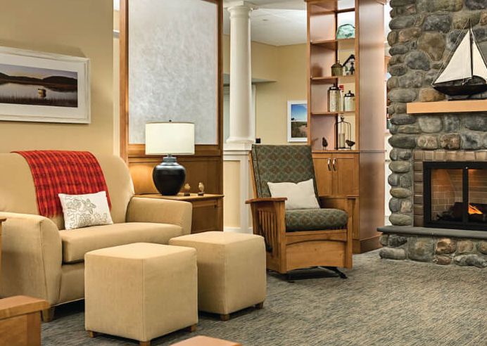 A cozy living room with comfortable seating, a stone fireplace, and well-placed furnishings.