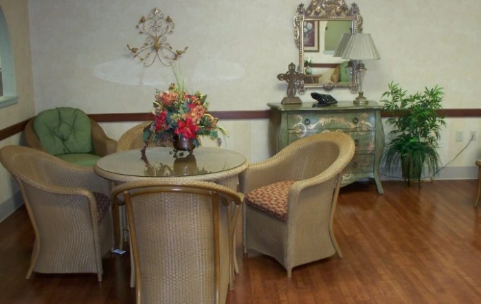 A cozy room with wicker furniture and a floral centerpiece.