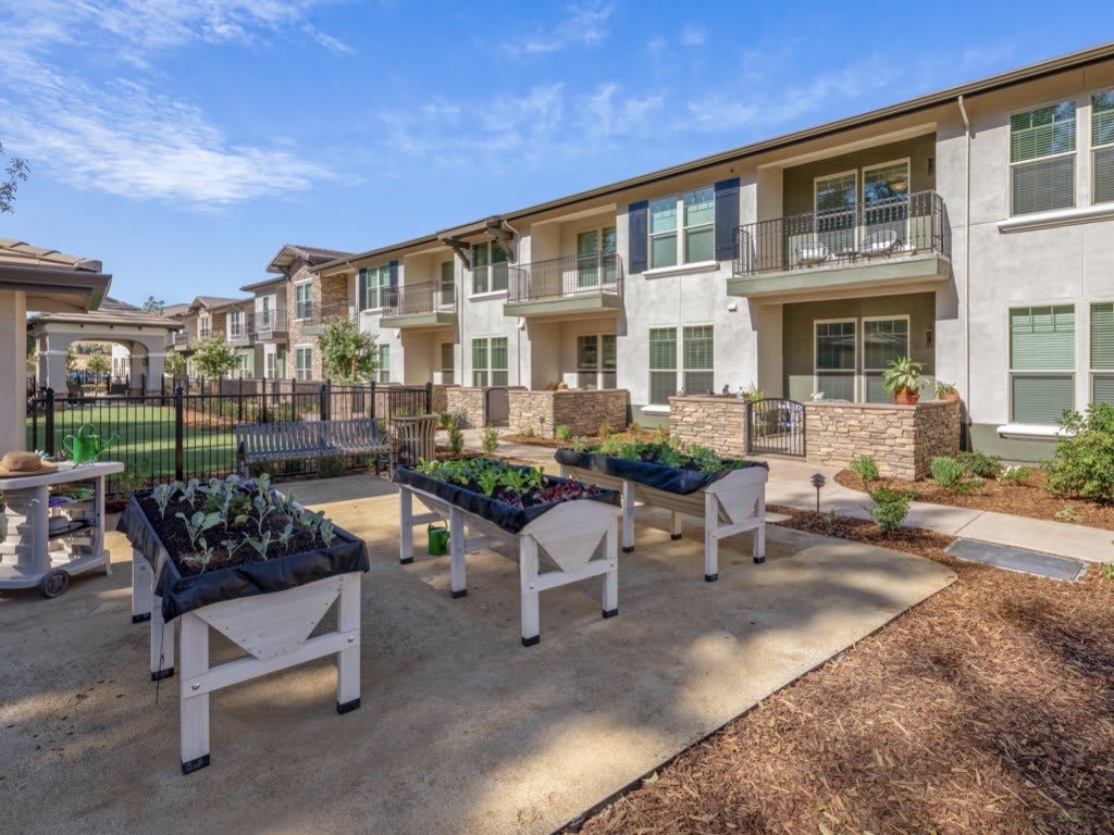 Apartment complex with outdoor garden planters.
