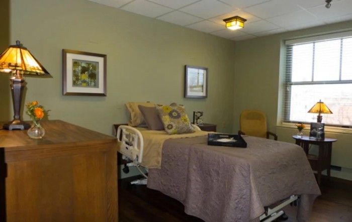 A cozy bedroom with a hospital bed and decorative elements.