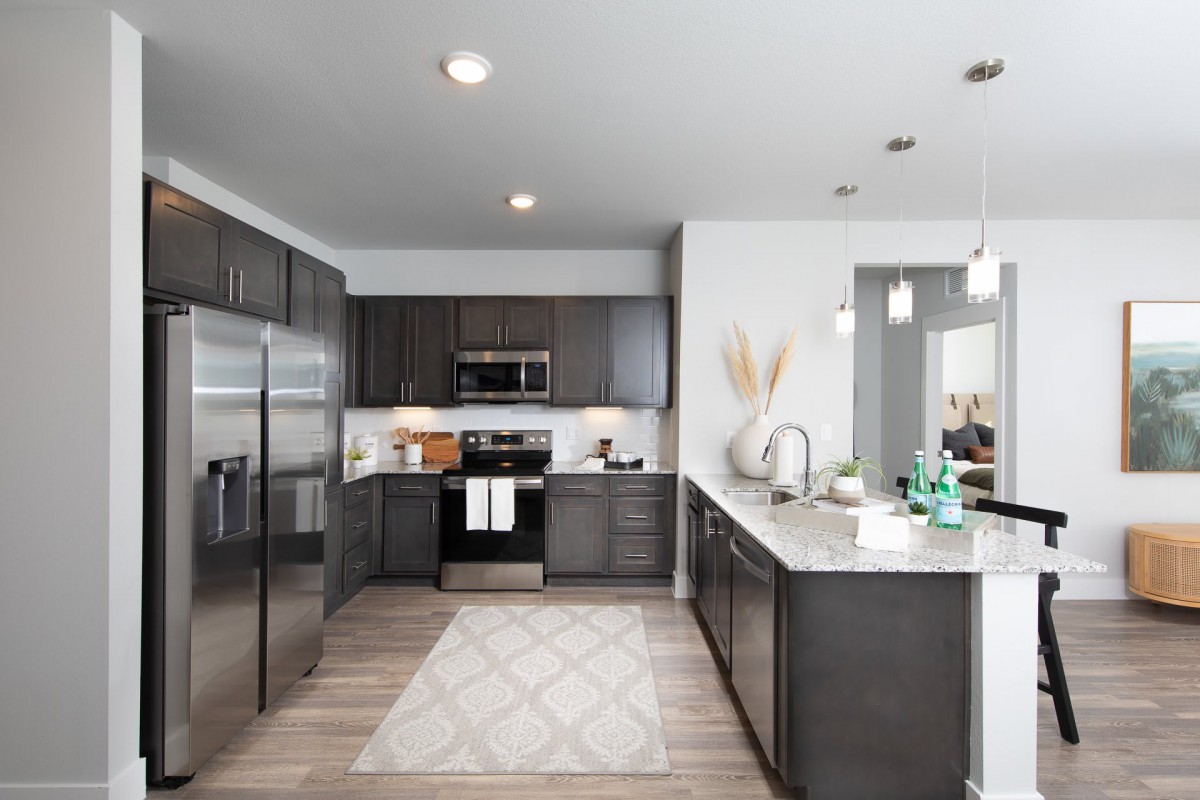 A modern kitchen with sleek cabinets and stainless steel appliances.