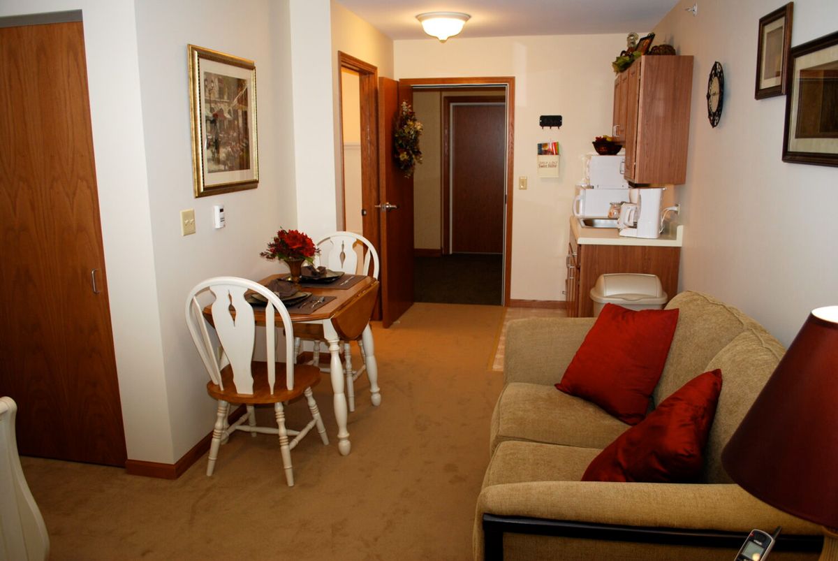 A cozy apartment living room with a dining area and comfortable furniture.